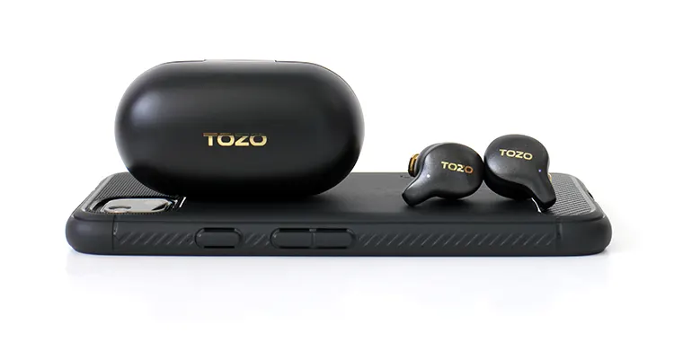 TOZO Golden X1 on top of smartphone