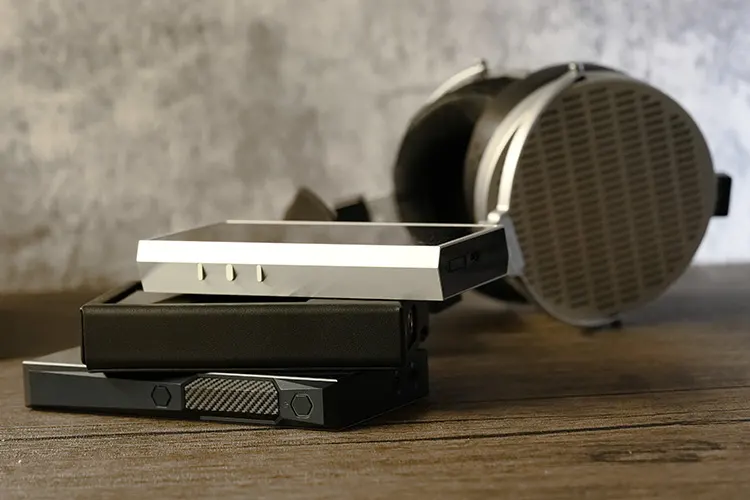 ONIX Overture XM5 beside FiiO M23 and MOONDROP headphones