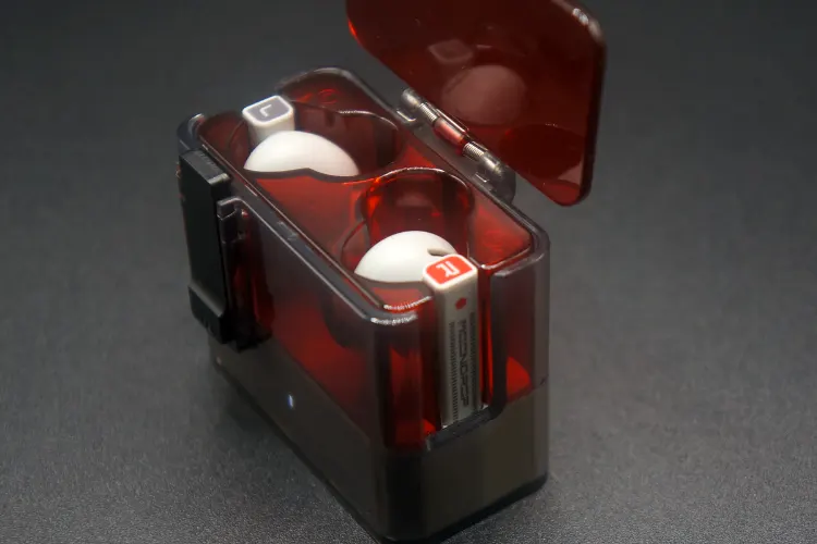 MOONDROP Ultrasonic earbuds in red cradle from the side