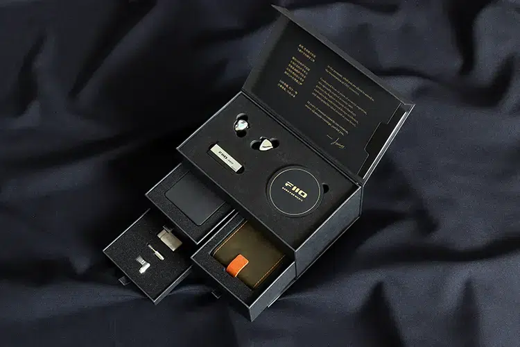FiiO FX17 unboxing with slide out trays on black satin