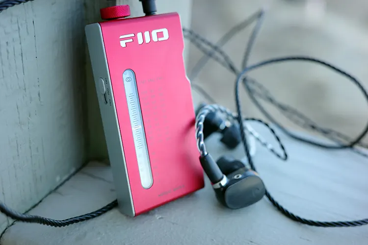 FiiO RR11 upright beside black earphones
