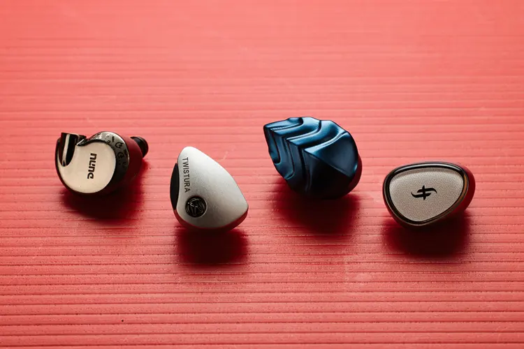 Twistura Woodnote beside 3 other IEMs