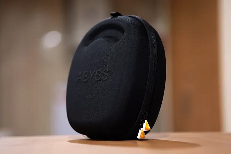 ABYSS JOAL carry case in black on wooden bench