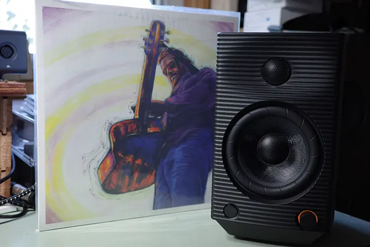 FiiO SP5 single speaker beside a record sleeve