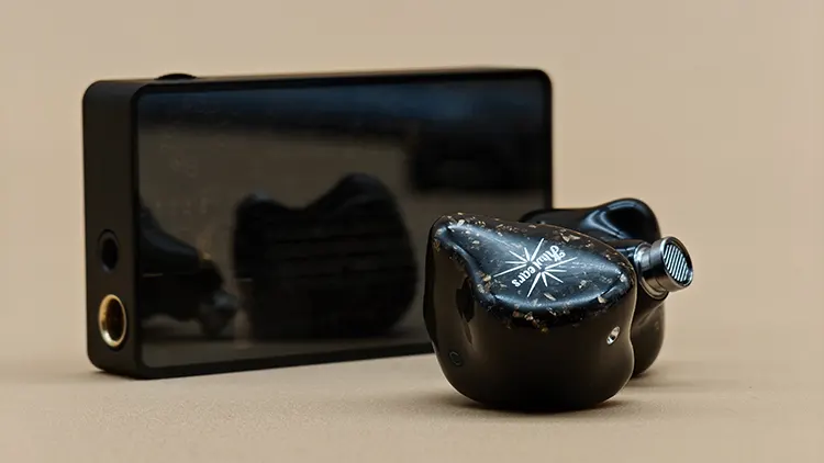 Kiwi Ears Astral shells beside Heartfield R1 dongle