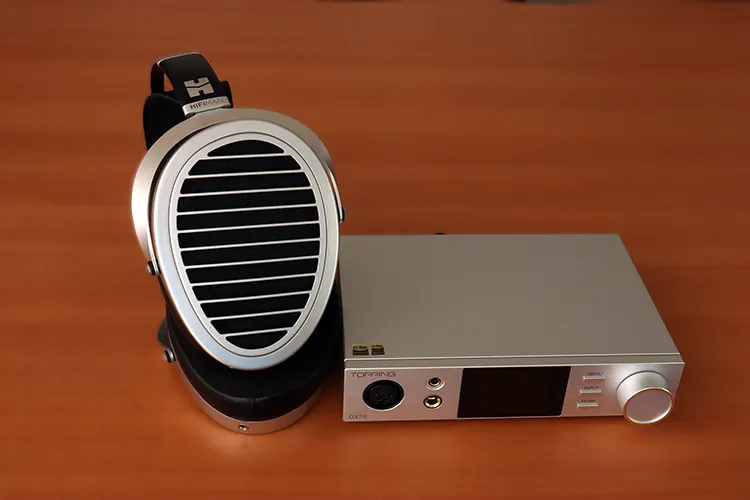 Topping DX5 II beside black and silver HIFIMAN headphones