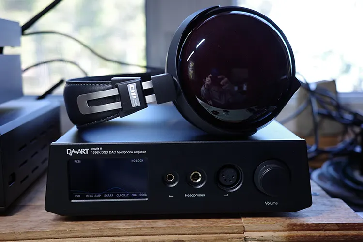 FiiO FT13 headphones on top of black YULONG Aquila III amplifier