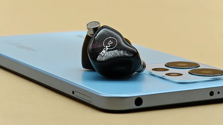 ZiiGaat Crescent shells on top of a blue smartphone closeup