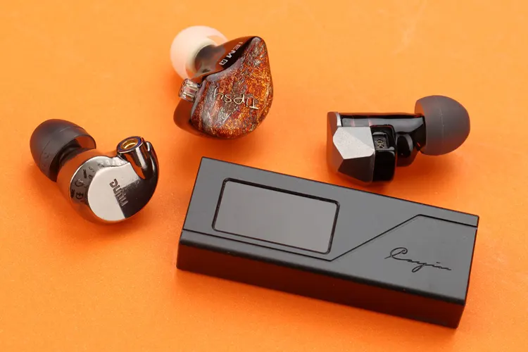 Cayin RU3 beside 3 IEMs