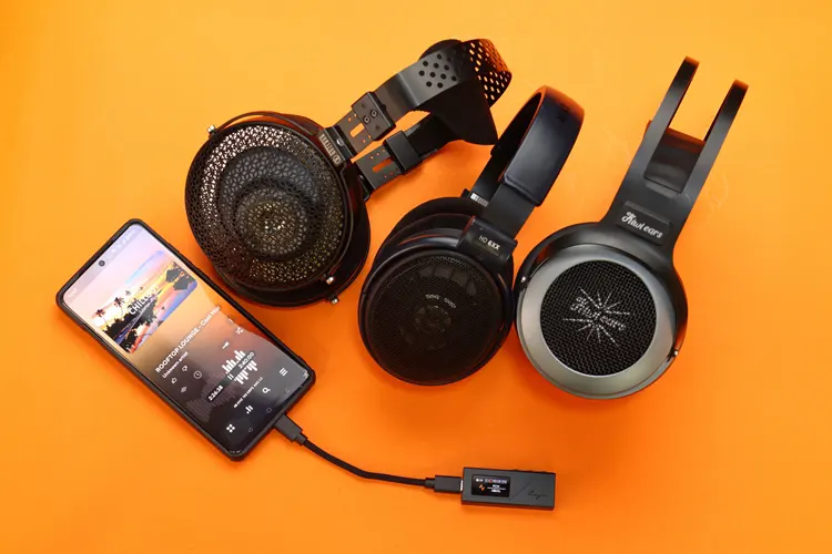 Cayin RU3 beside 3 headphones