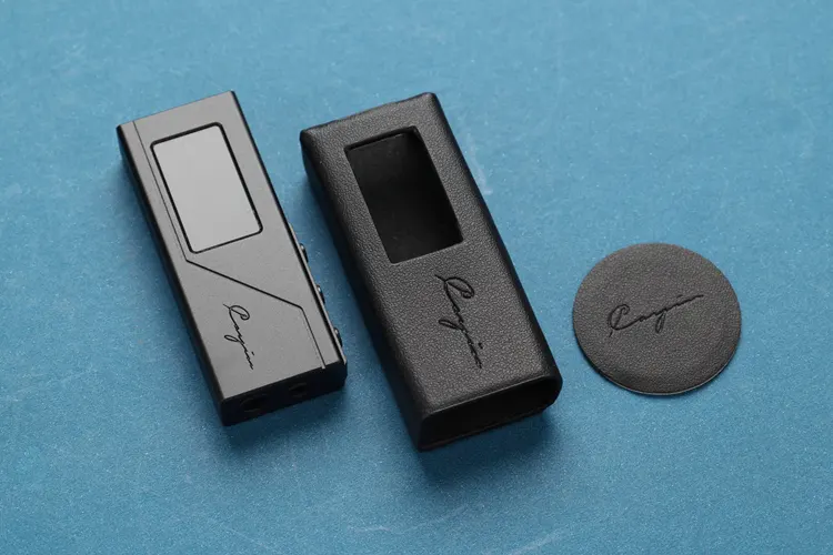 Cayin RU3 beside a black leather case
