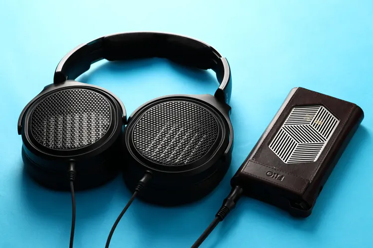 FiiO JT7 headphones laid flat connected to the FiiO M15S DAP