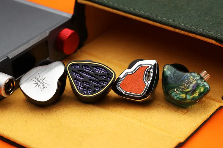 Tipsy M3 IEM shell beside 3 IEM shells