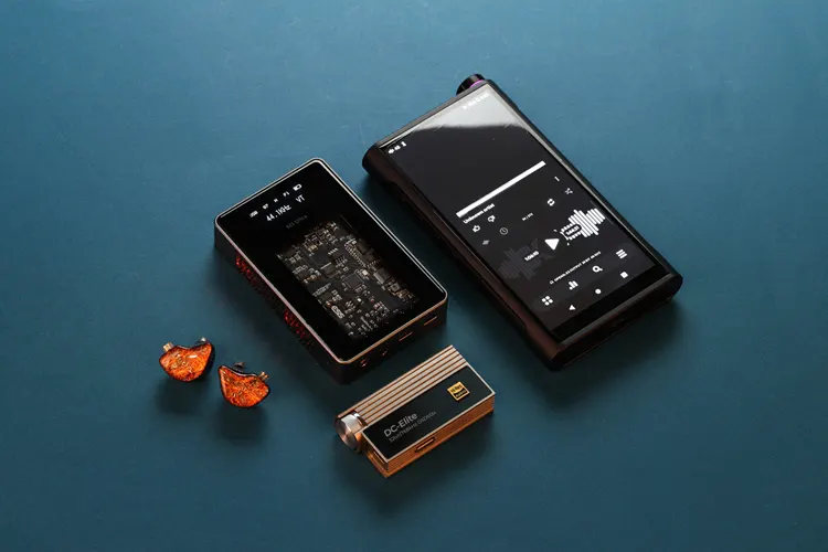 Tipsy M5 shell beside a FiiO DAP and 2 dongles