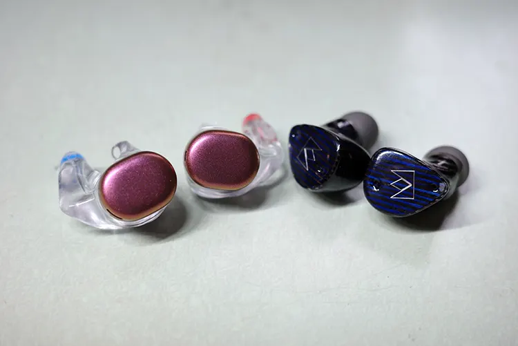 Noble FoKus Prestige Encore earbuds beside UE Drops earbuds