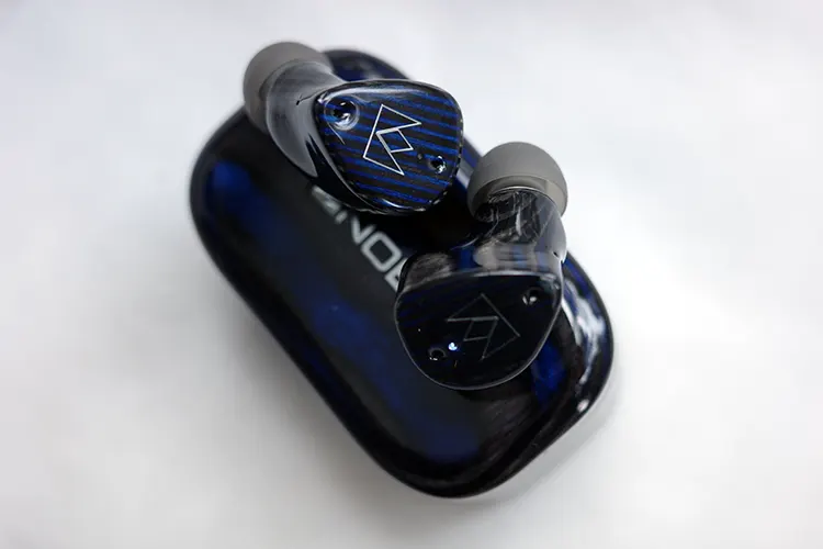 Noble FoKus Prestige Encore earbuds on top of the cradle