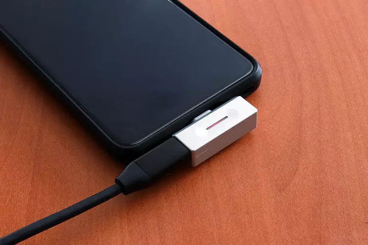 FiiO AIR LINK inserted into the base of a smartphone