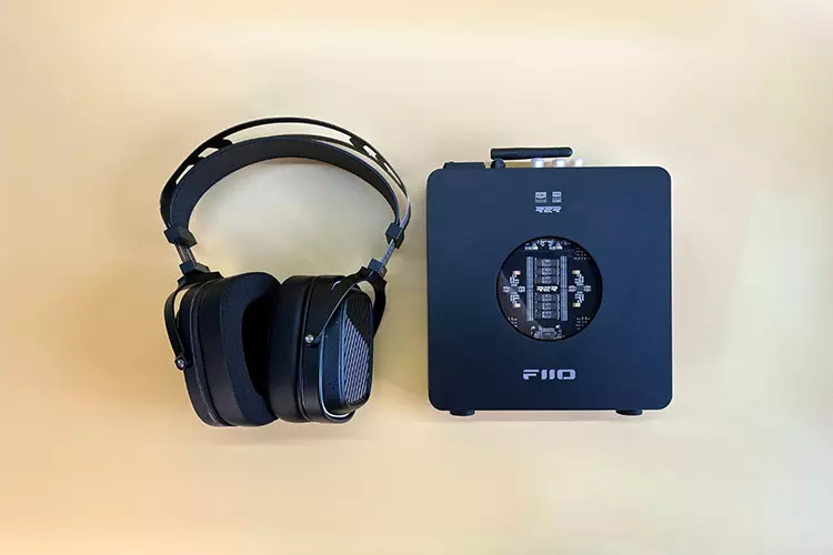 HarmonicDyne Romantic headphones beside FiiO K11 R2R amplifier
