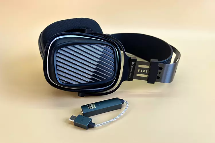 HarmonicDyne Romantic headphones beside iFi Audio dongle DAC