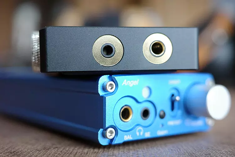 EarMen L-Amp MK2 on top of a blue EarMen Angel amplifier