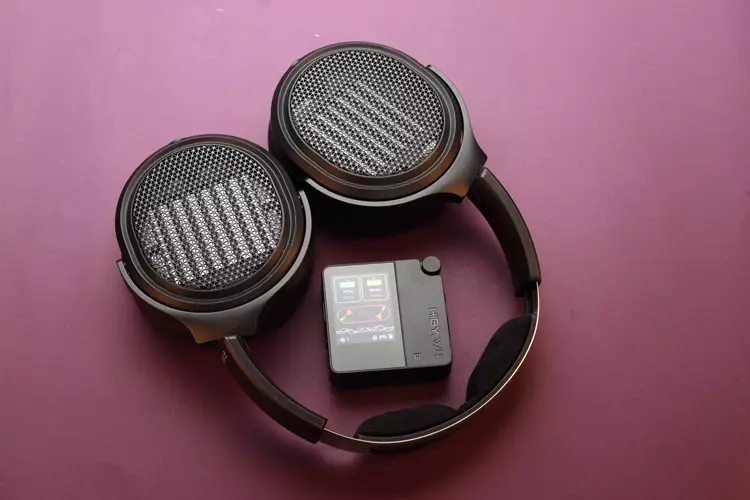 HiBy W4 beside FiiO headphones
