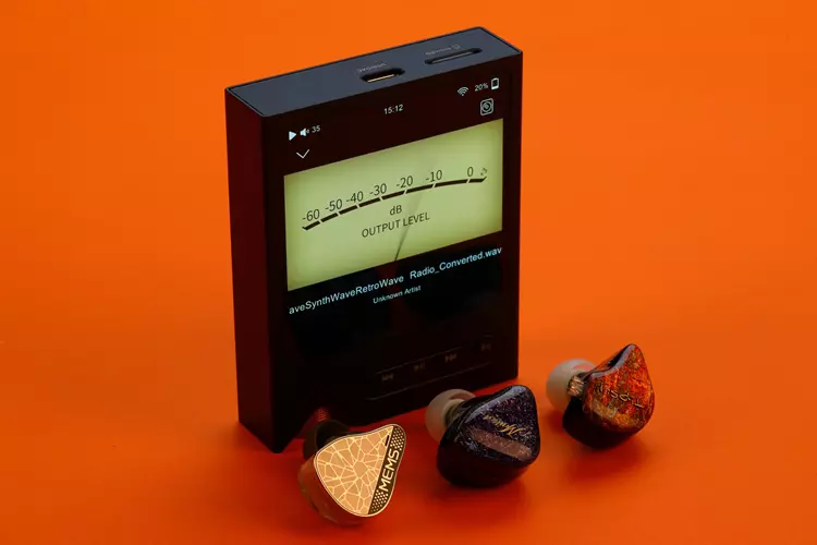 ONIX XM2 beside 3 earphones