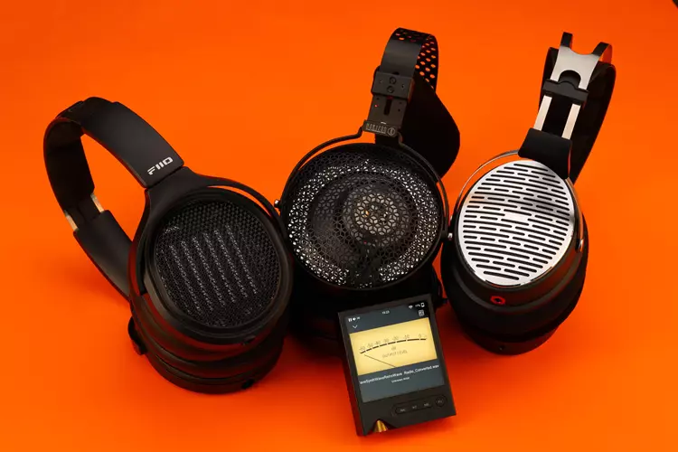 ONIX XM2 beside 3 headphones