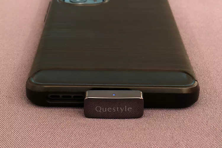 Questyle QCC Dongle Pro connected to the base of a smartphone
