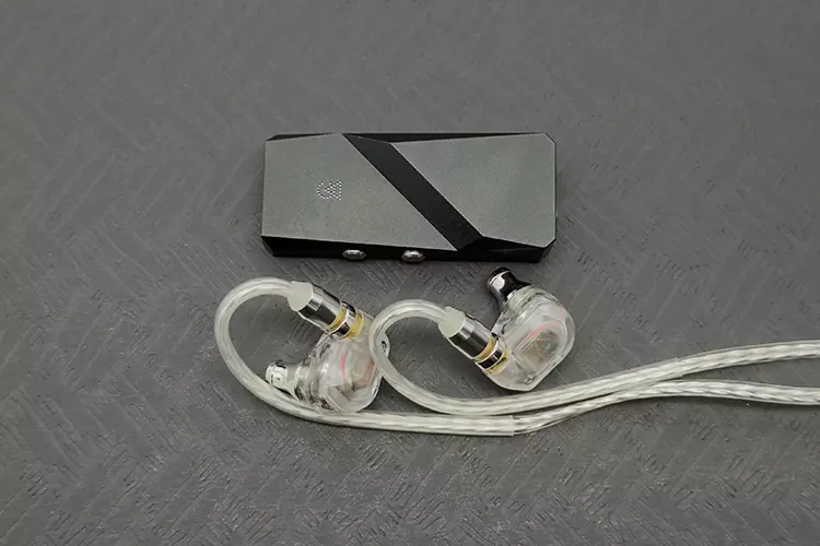 Campfire Audio Iris beside Campfire Audio Relay dongle