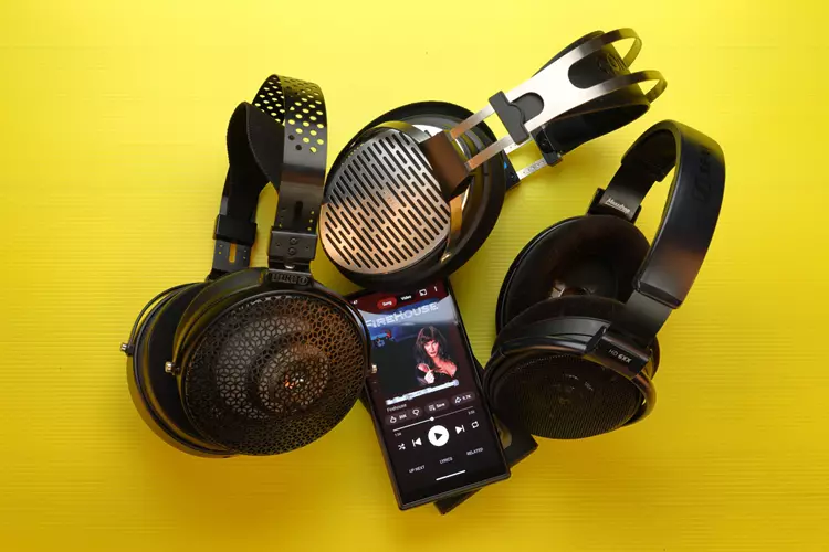 FiiO M33 R2R beside 3 headphones