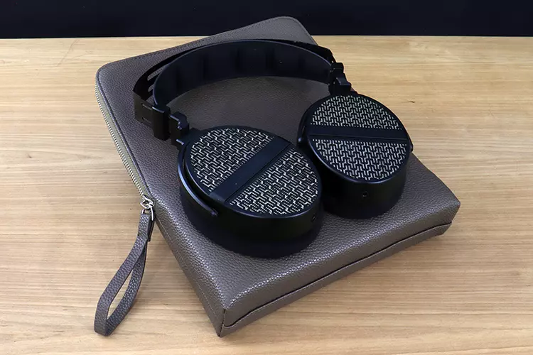 THIEAUDIO Cypher on top of its leather carry case