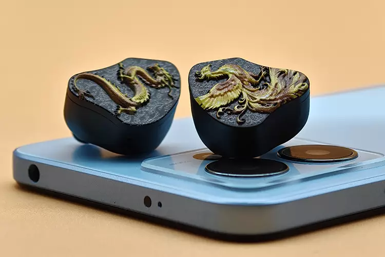 CVJ MYTHERA shells on top of blue smartphone