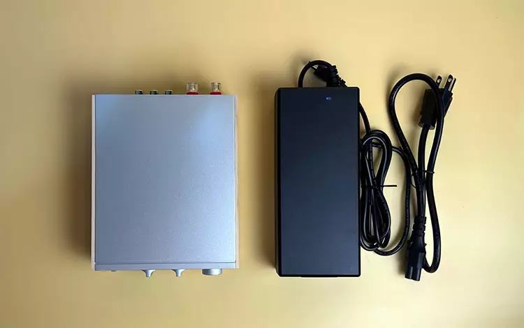 FiiO Jade Audio Level 1 amplifier beside its power supply