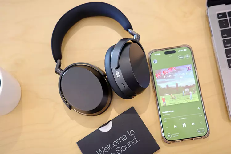 Sennheiser MOMENTUM 5 Wireless Review beside laptop and a phone