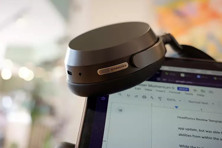 Sennheiser MOMENTUM 5 Wireless earcup on top of MacBook screen