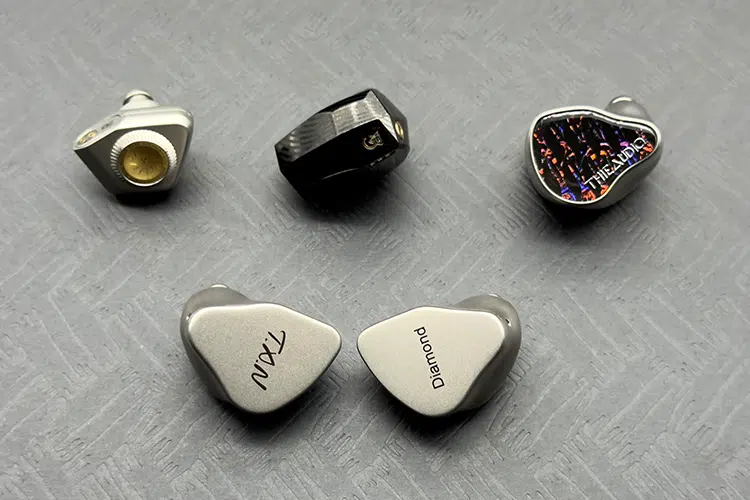 TXN Diamond shells beside three other IEMs