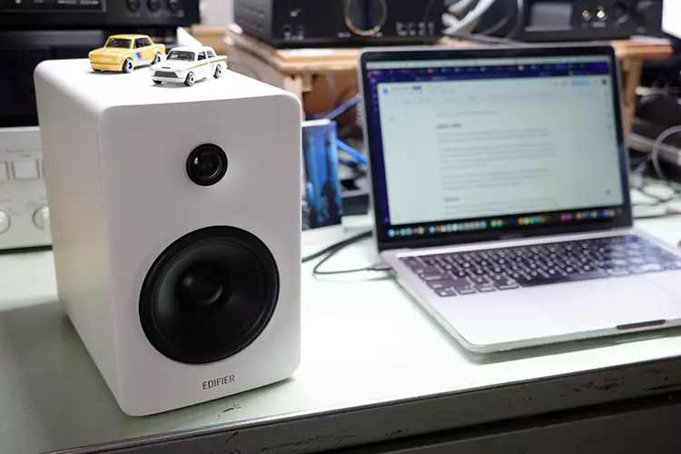 Edifier M90 left speaker beside a laptop