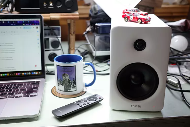 Edifier M90 right speaker beside a laptop